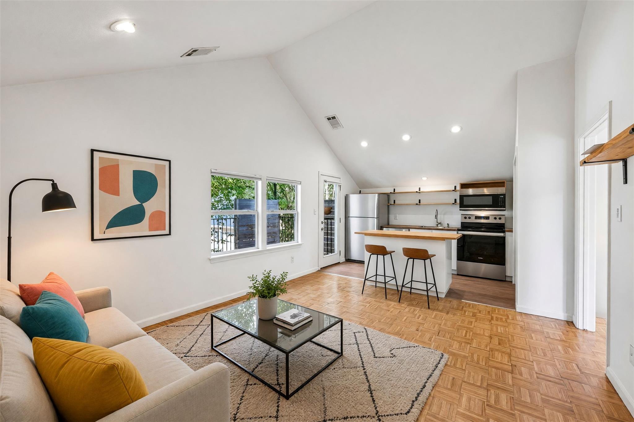 Vaulted ceilings soar over a bright open living s