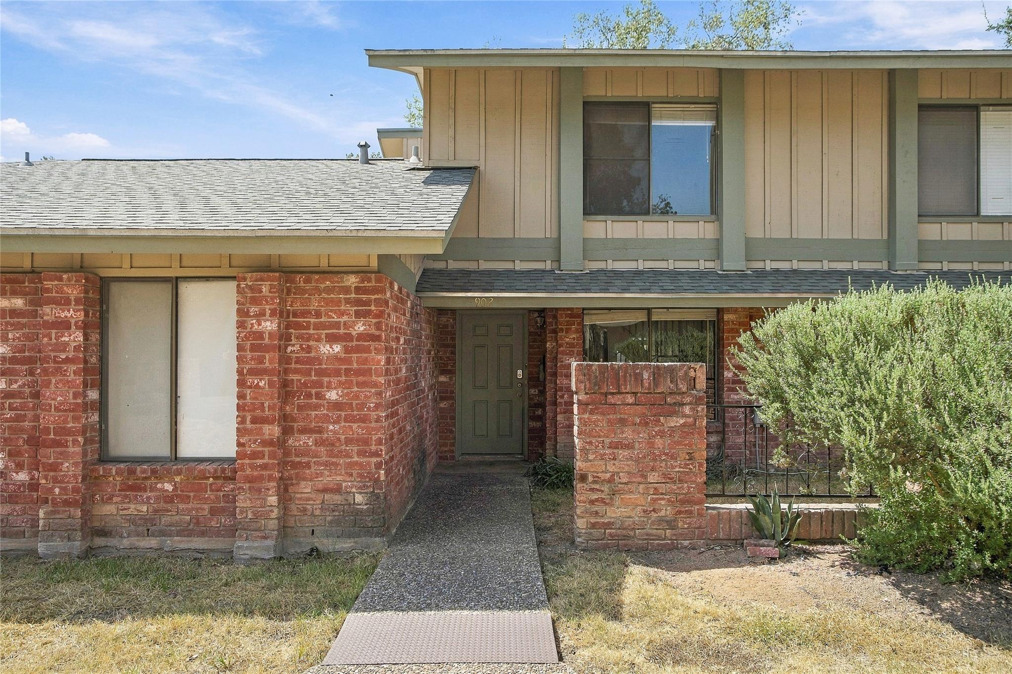 A concrete walkway leads to the private entry of 