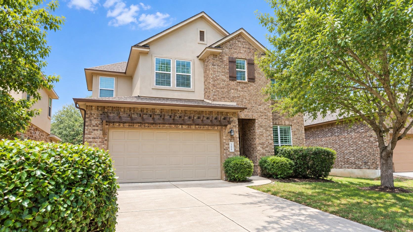 Stone and stucco finishes define this multi-level