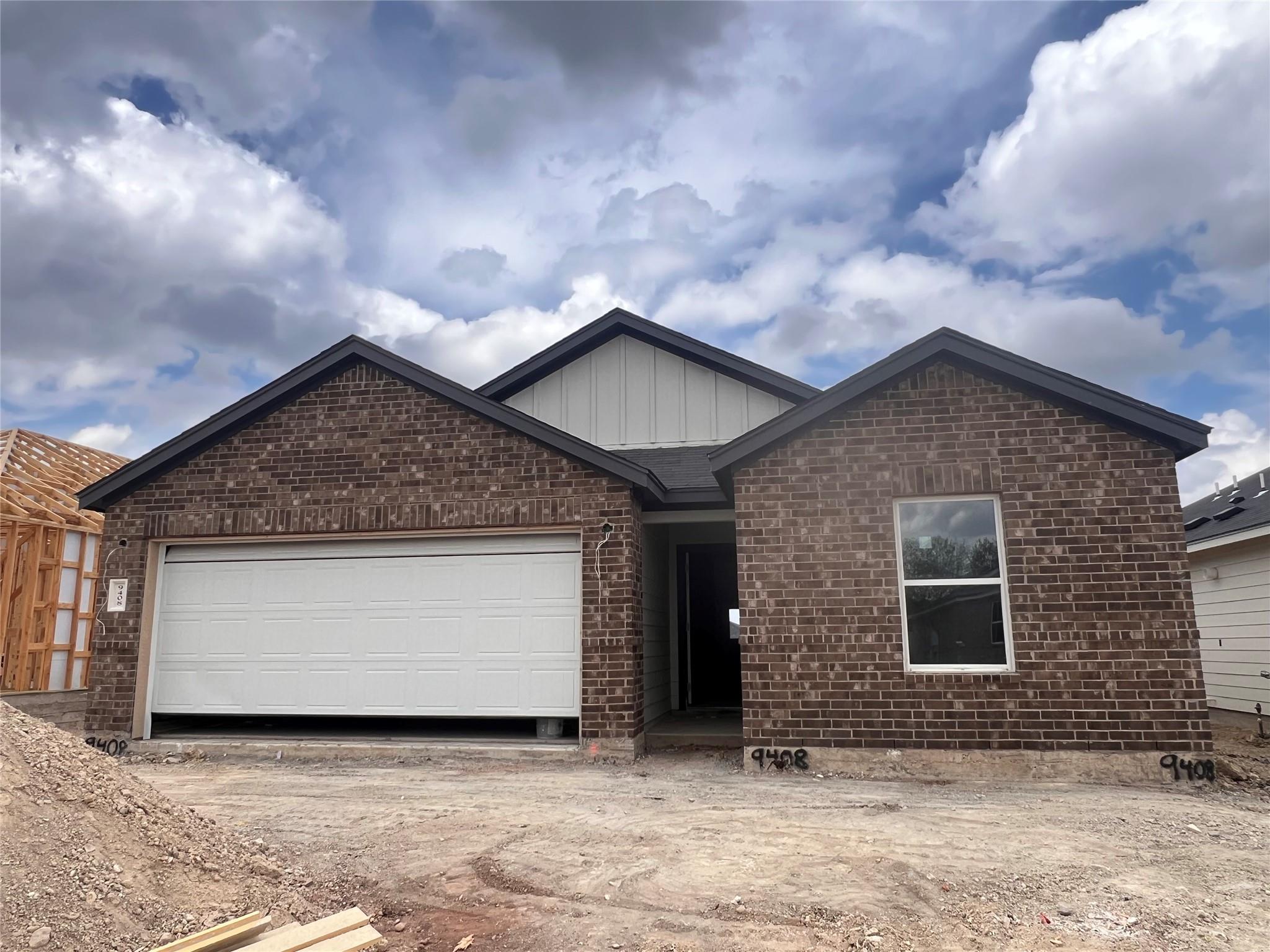 Classic brick exterior and a gabled roofline defi