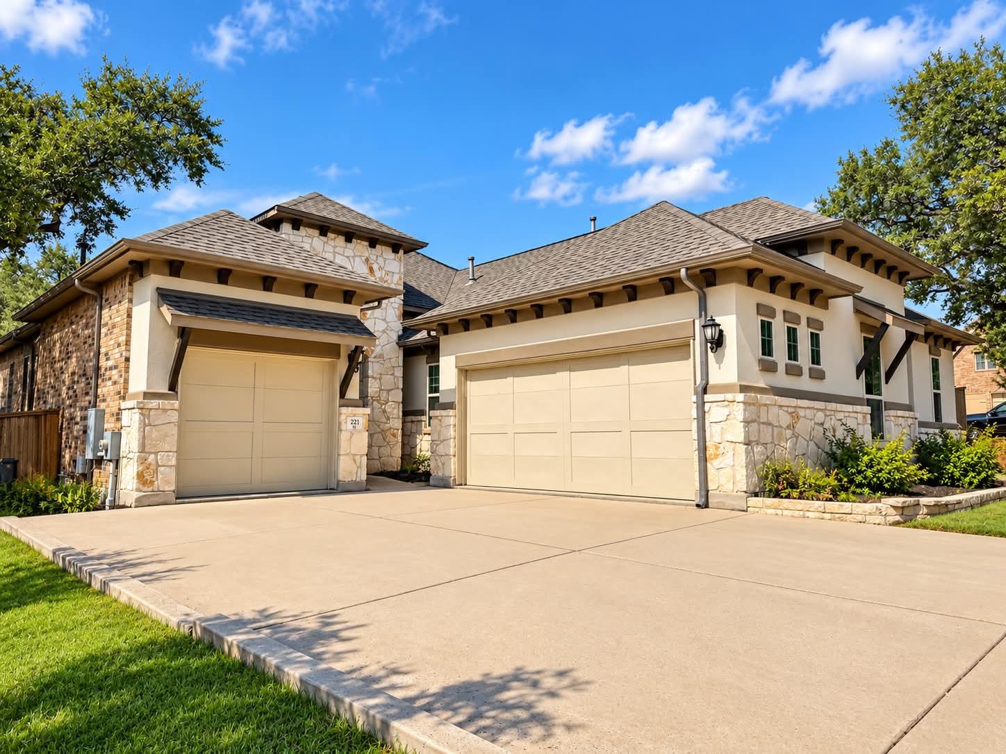 A spacious concrete driveway leads to the three-c