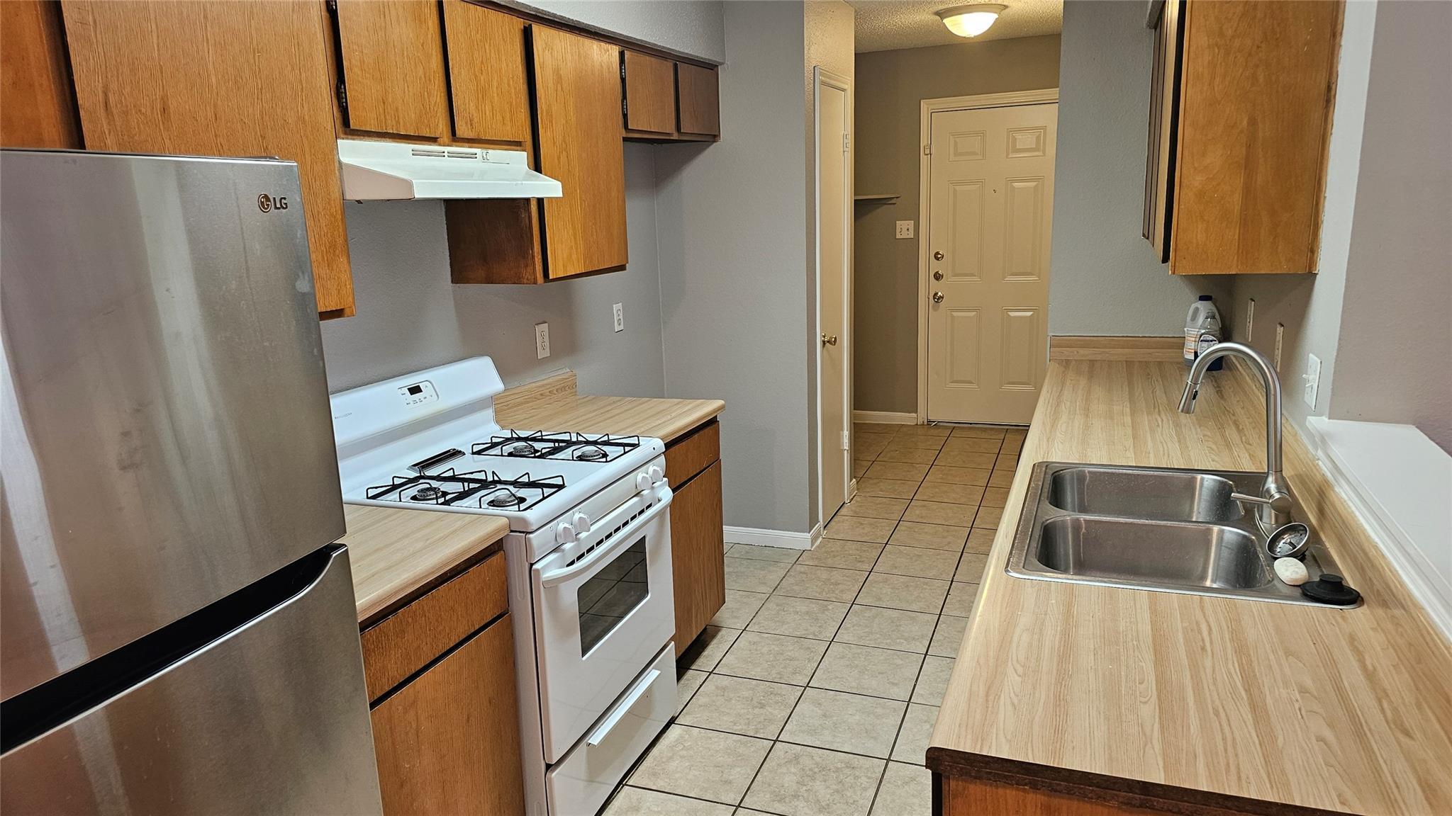 Tiled flooring runs through this kitchen design f
