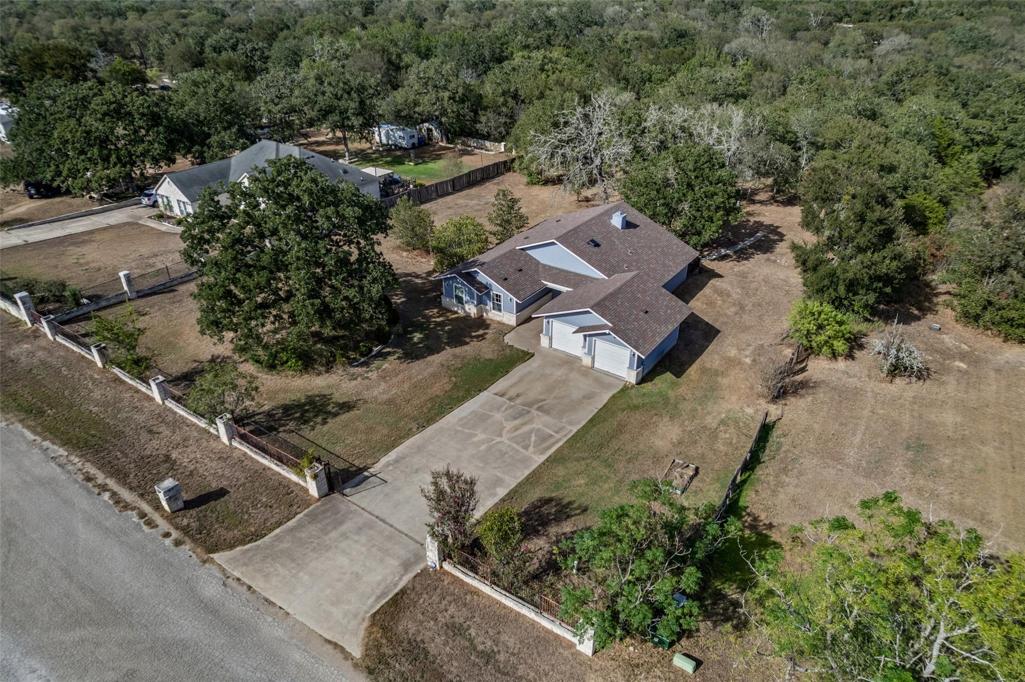 Mature trees surround this classic home featuring