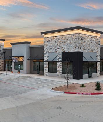 Modern stone facade accents this contemporary com