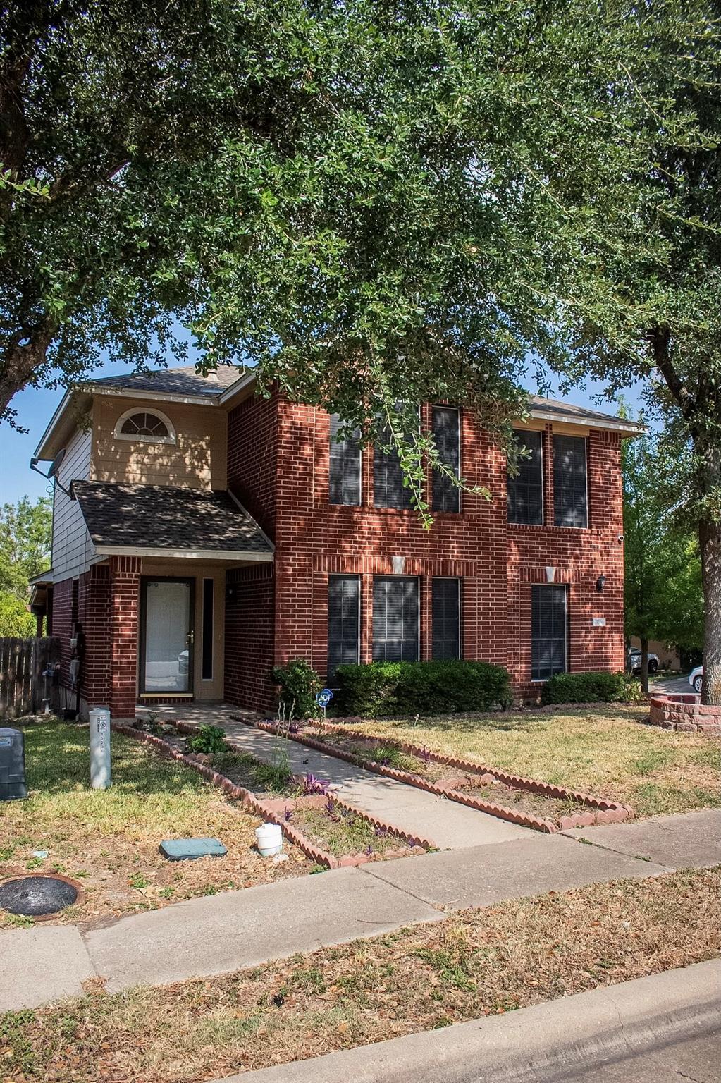A classic brick exterior and well-maintained land