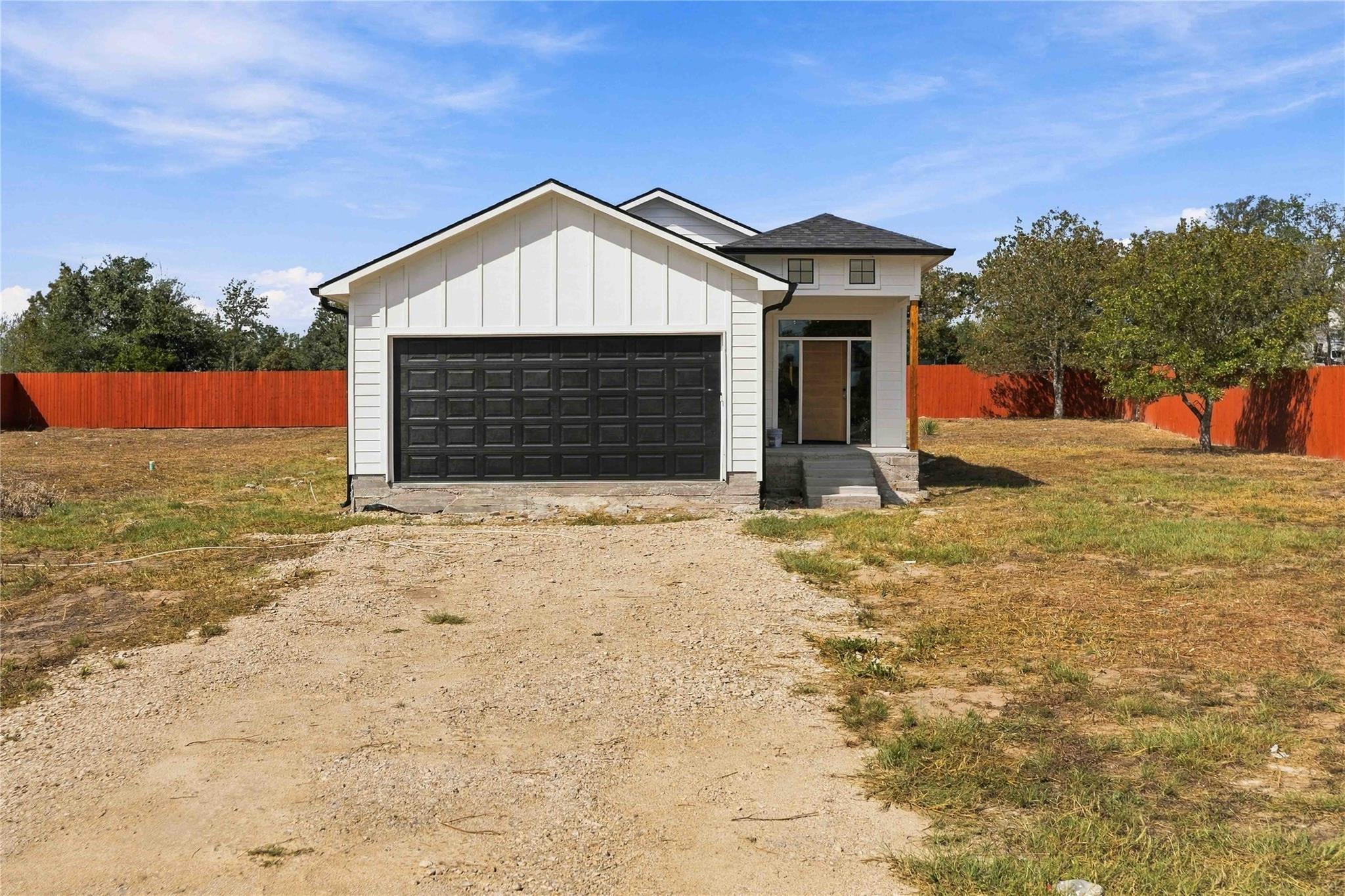 Modern vertical siding and a contrasting dark gar
