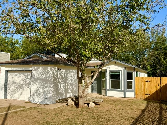 Mature trees shade the inviting exterior of this 