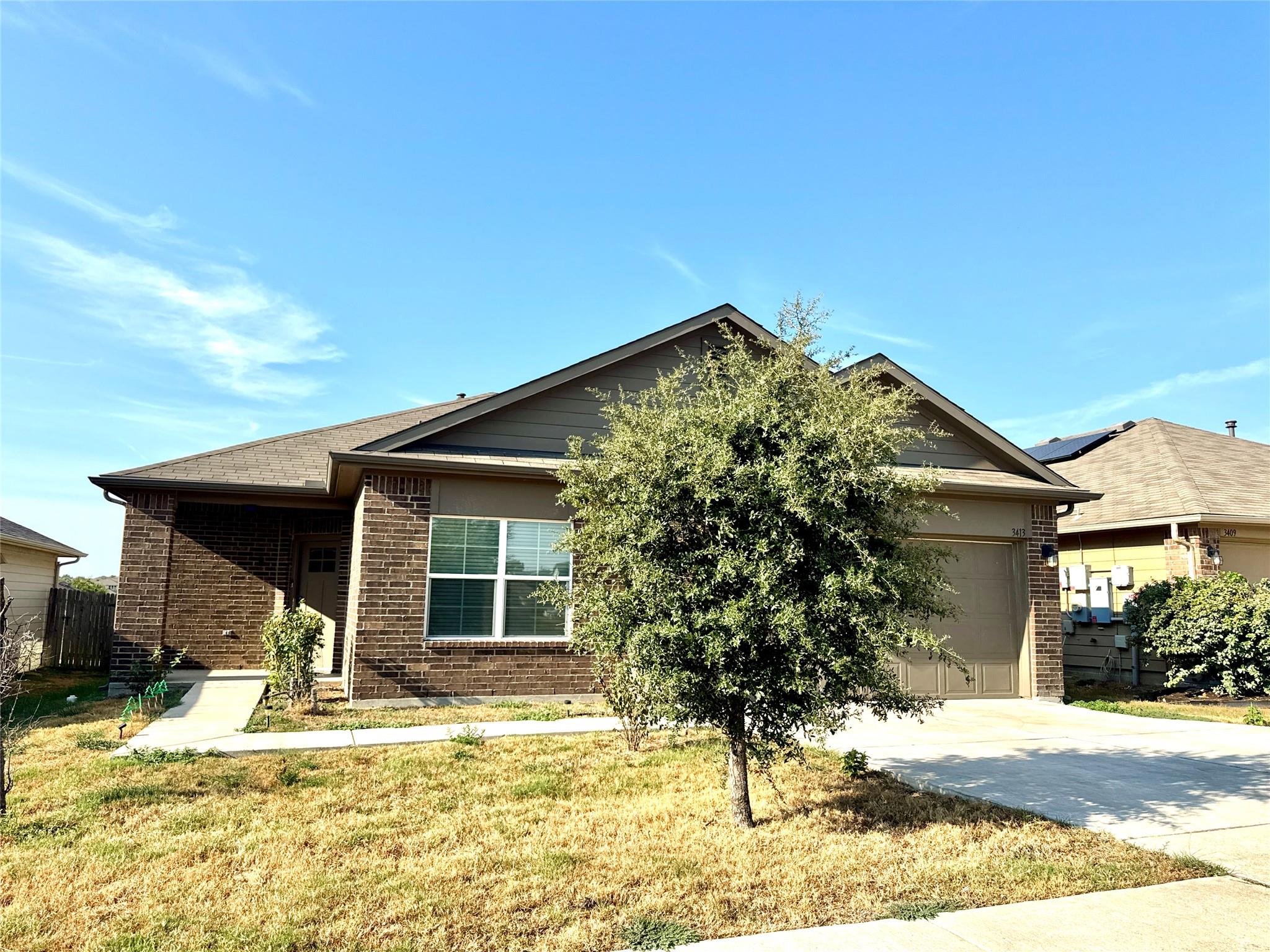 An inviting classic brick elevation pairs with a 