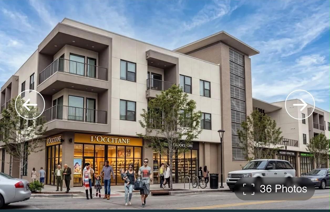 A modern multi-story building features clean arch