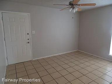Tiled flooring and neutral walls define this vers