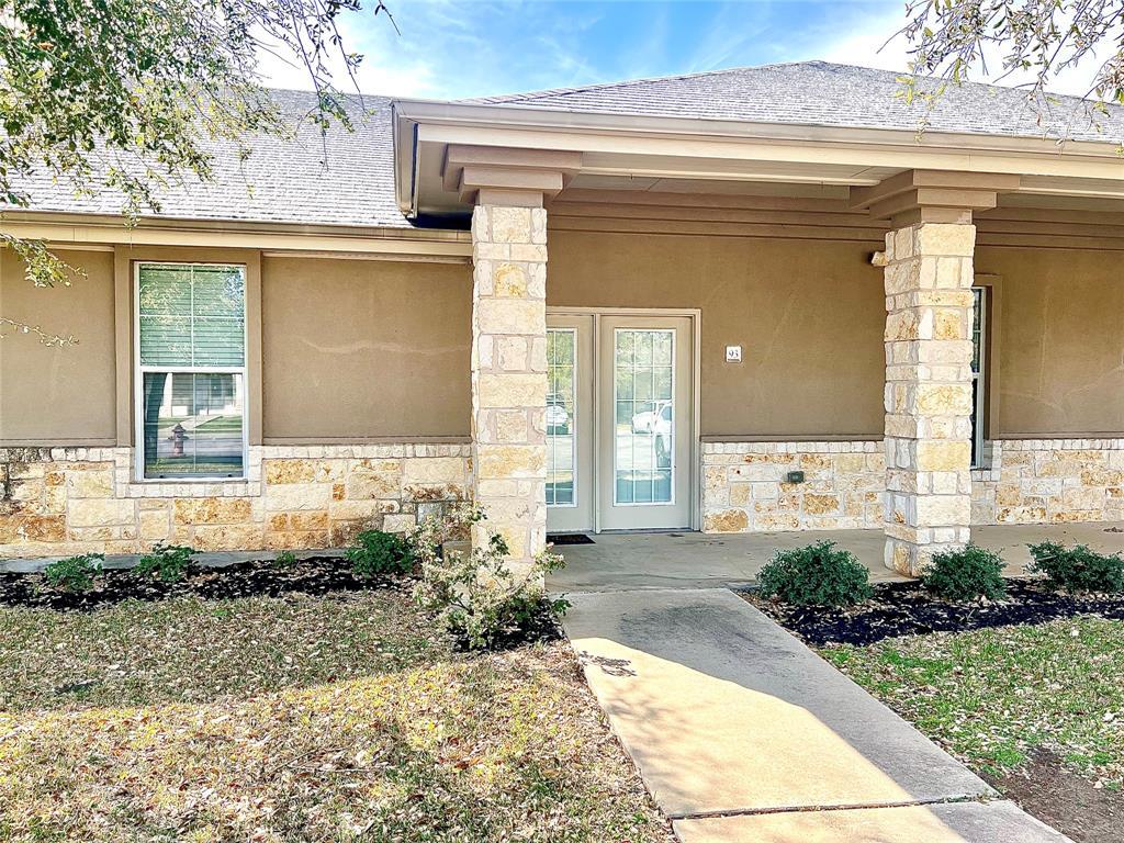 Stone pillars support the deep covered porch, fra