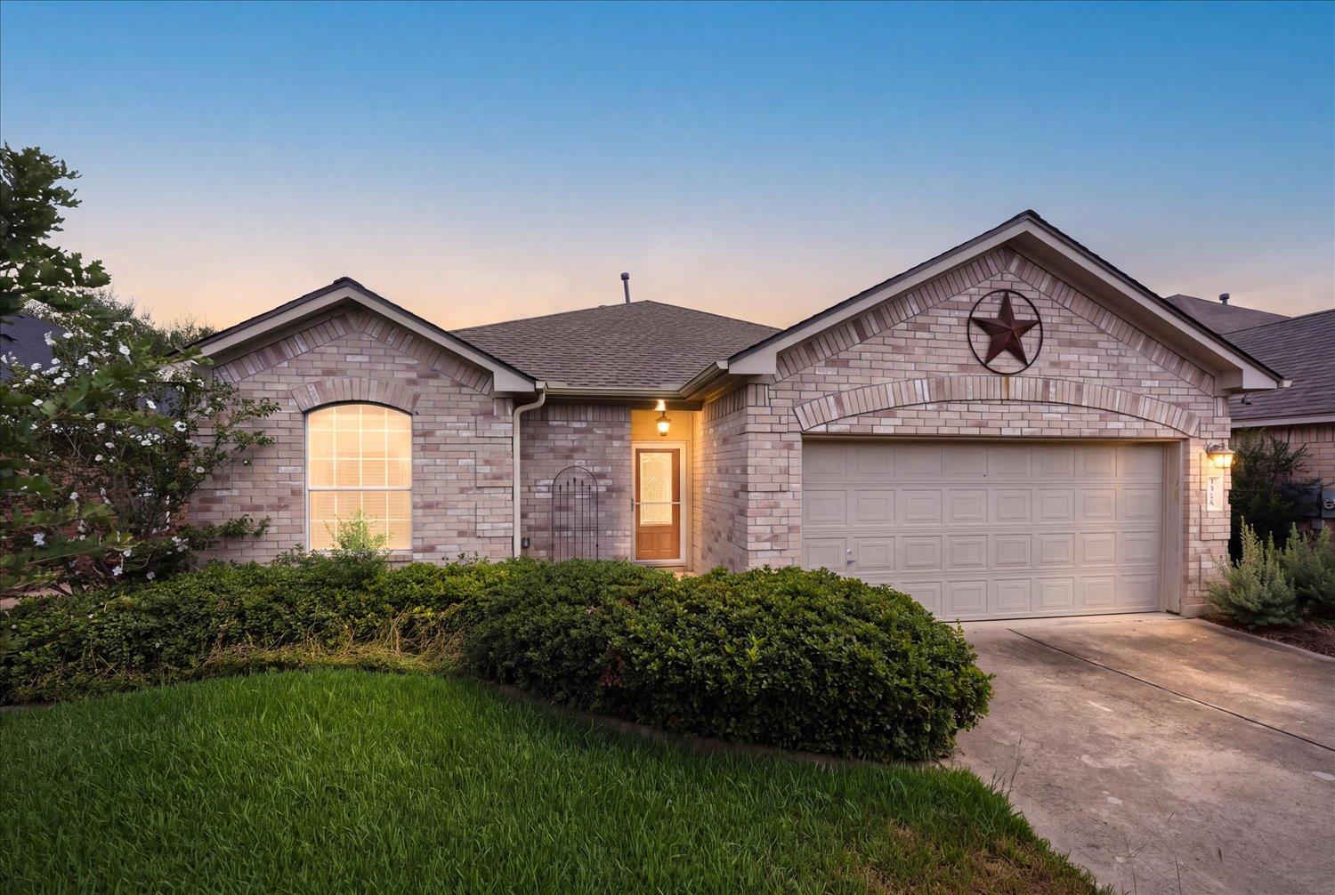 A classic brick exterior and neat landscaping fra