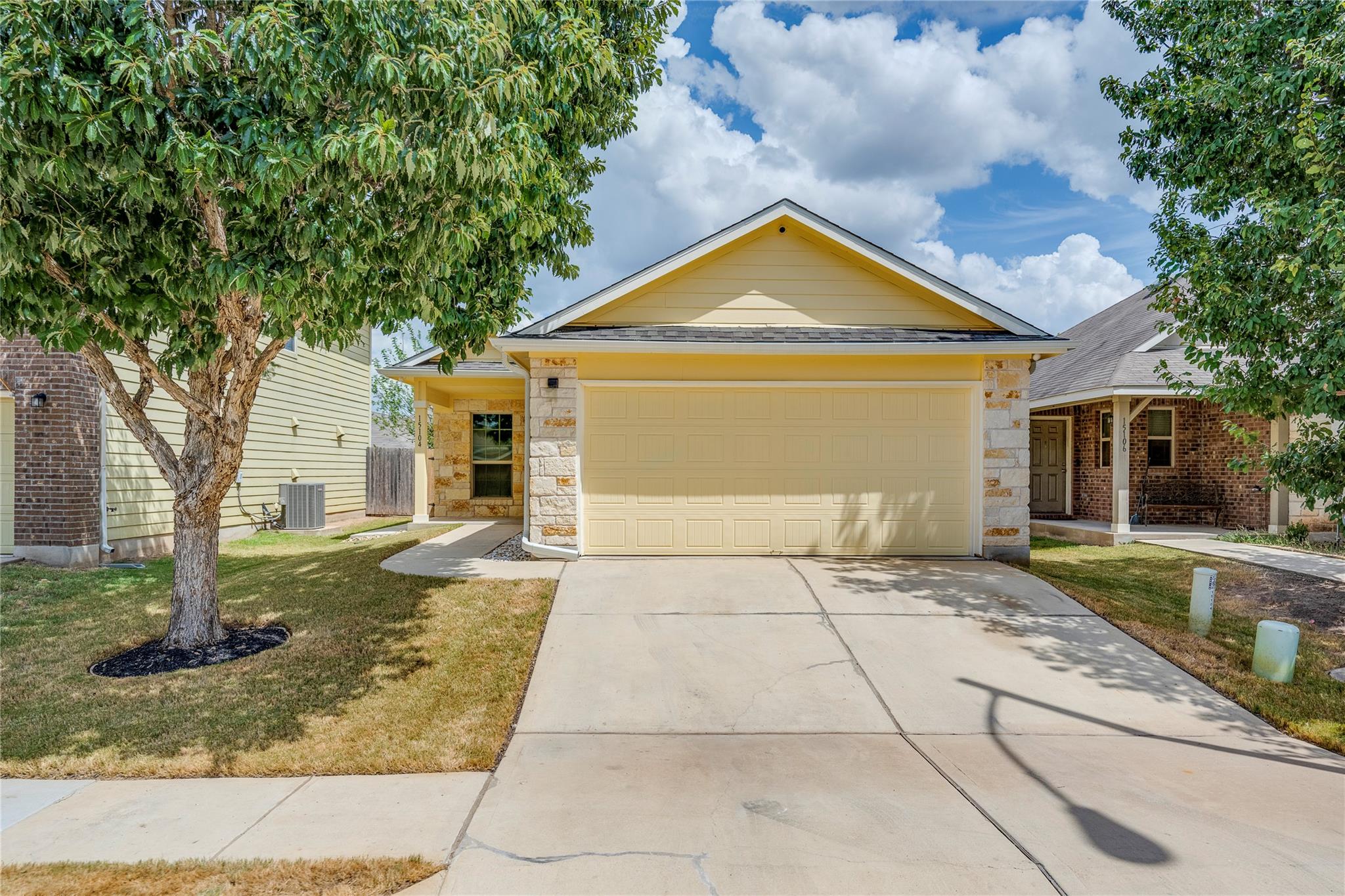 Charming stone accents and a wide driveway define