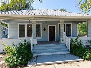 An inviting covered front porch leads to the entr