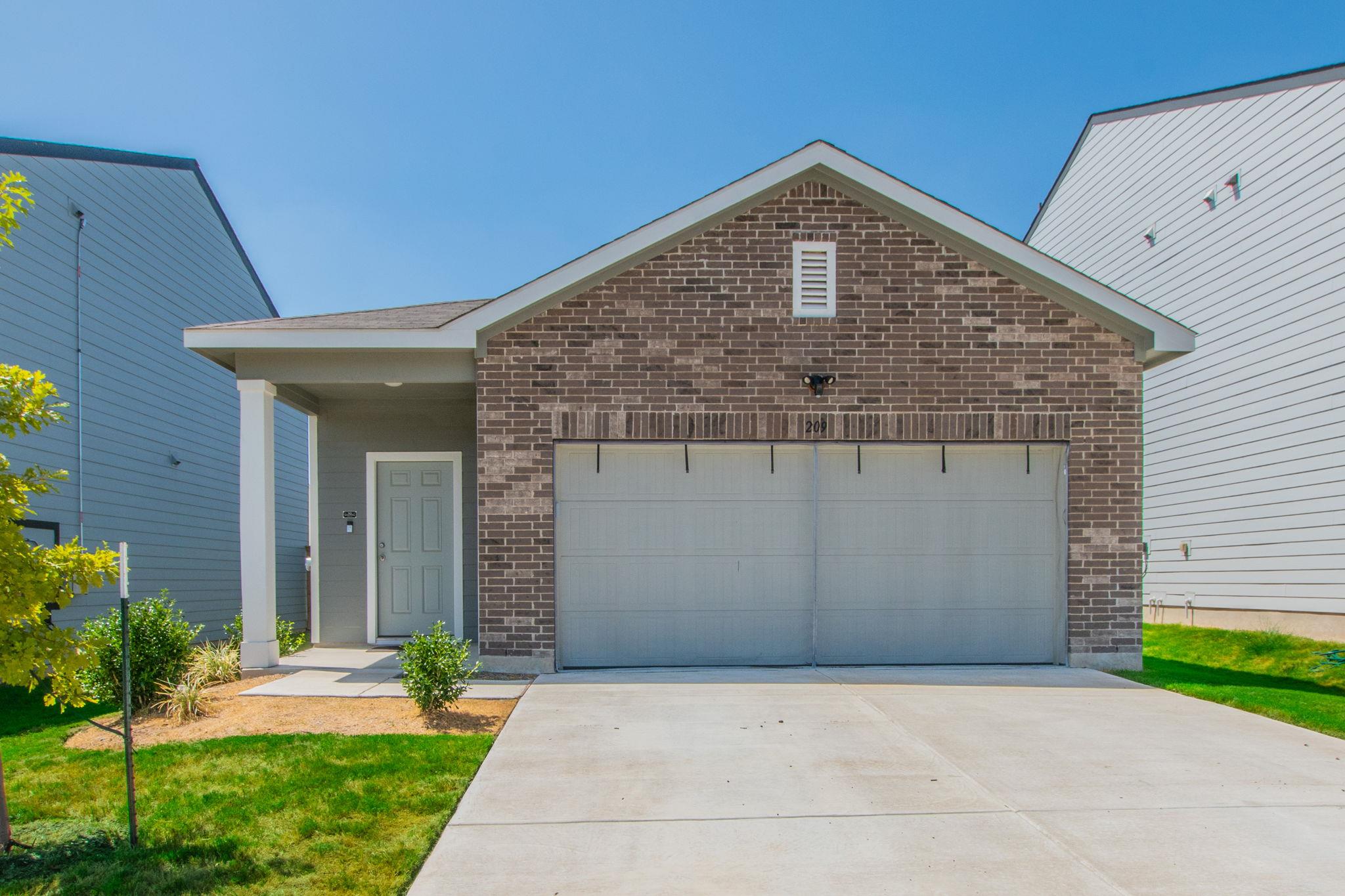 An inviting front porch and classic brick facade 