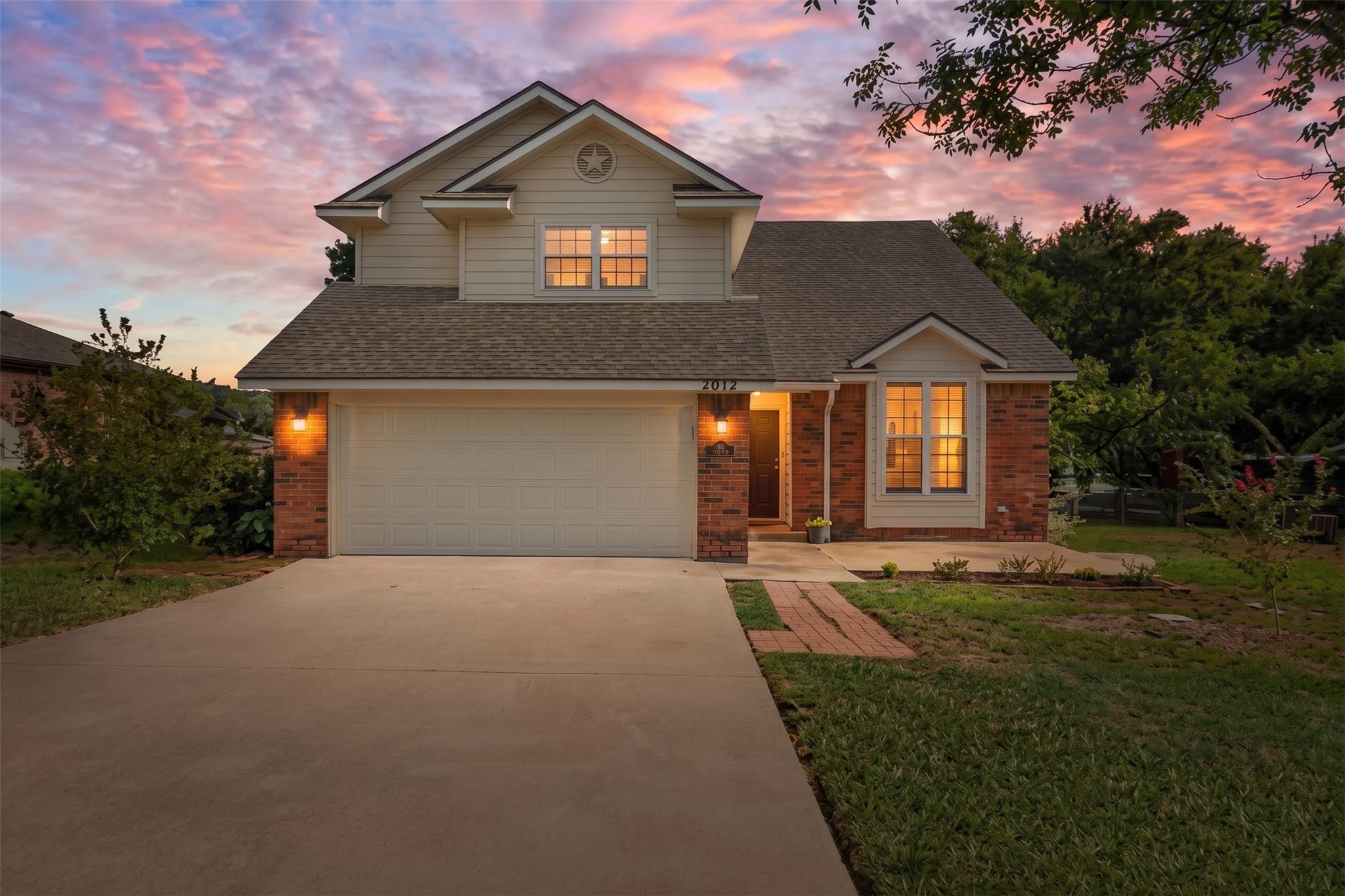 A classic brick and siding exterior features a fr