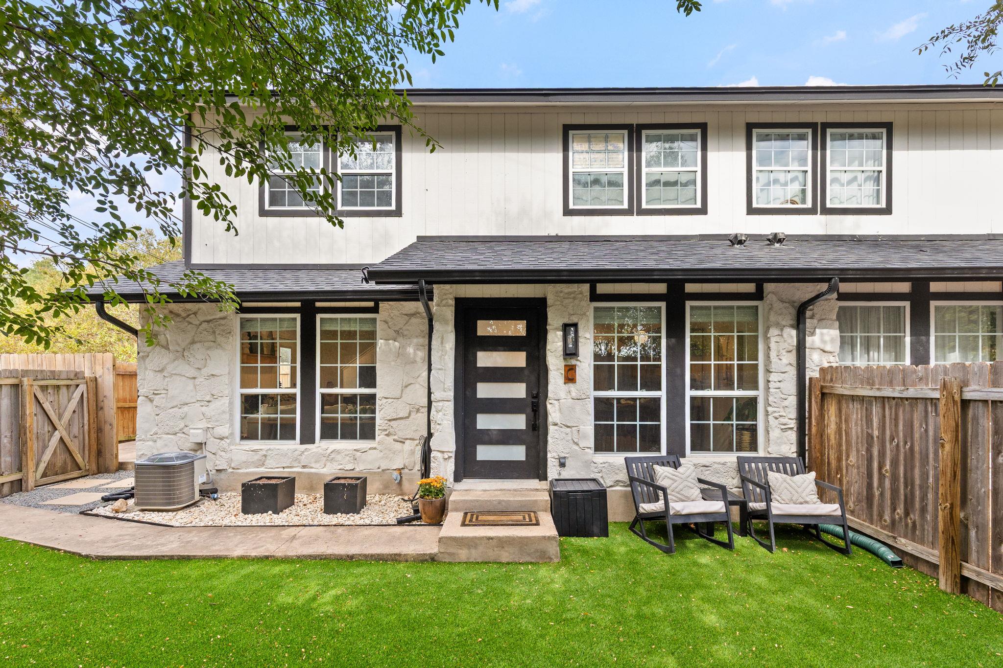Textured stone veneer and neat board siding creat