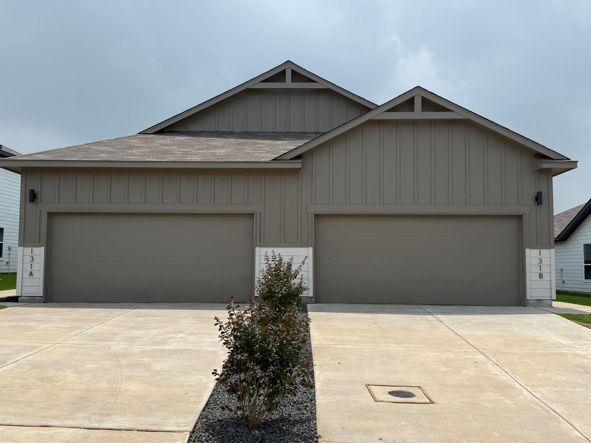 Board and batten siding pairs with concrete drive