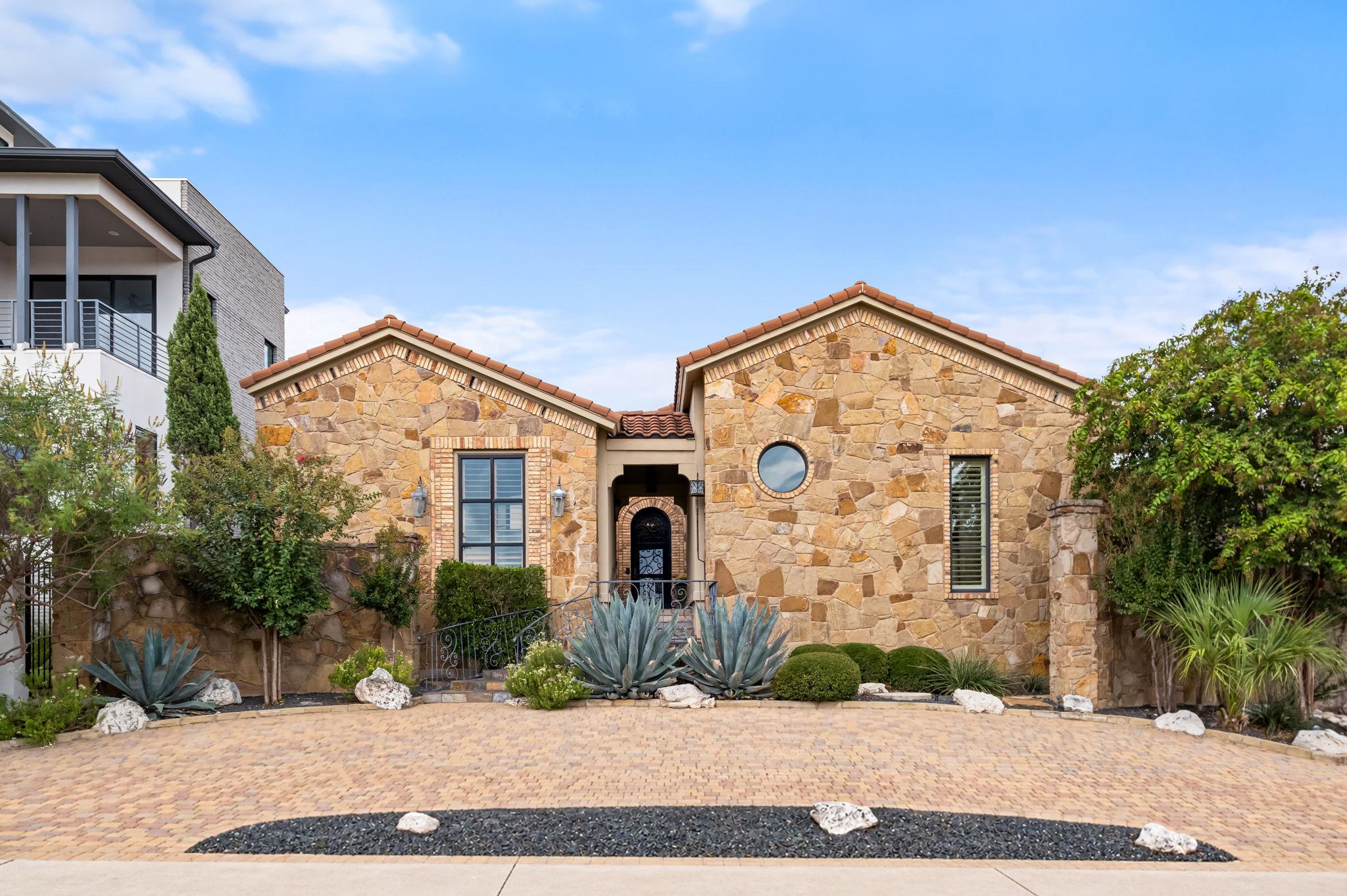 Gable rooflines and textured stone facades establ