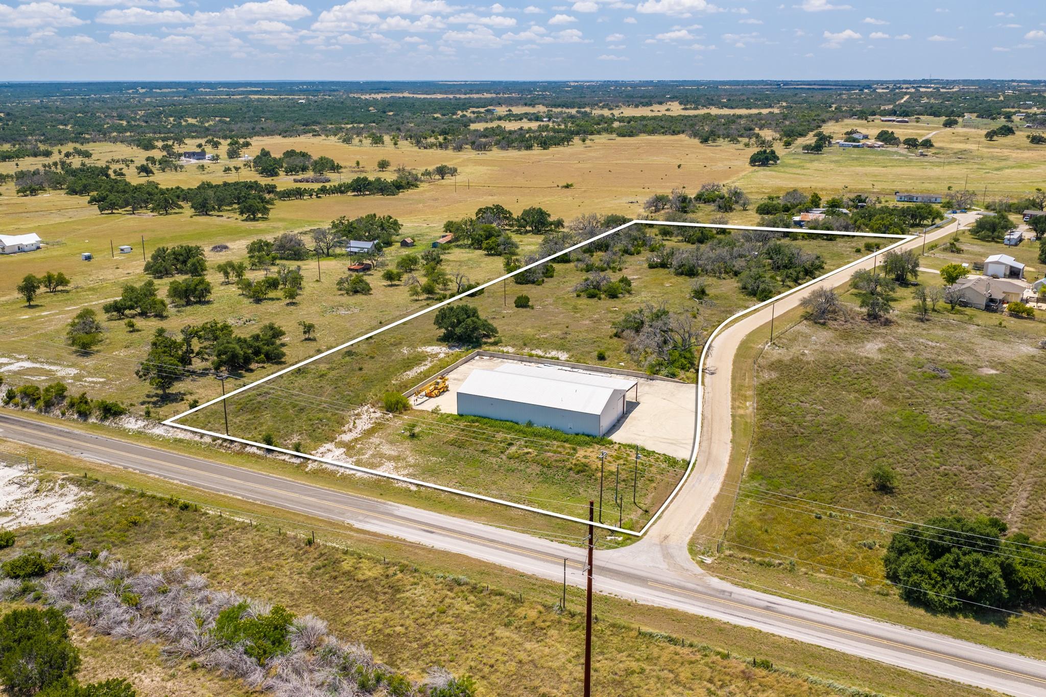 A spacious outbuilding sits on an expansive count