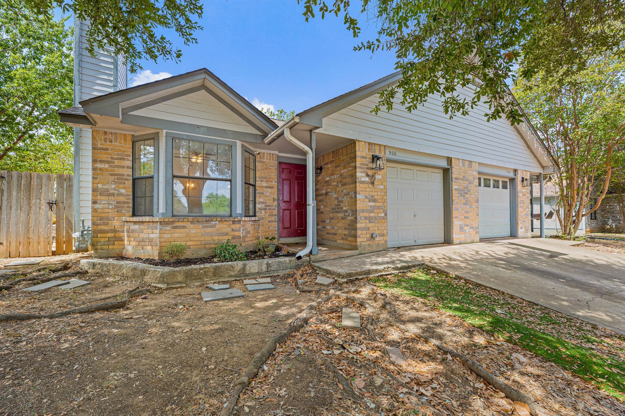 Classic brick accents and a two-car garage define