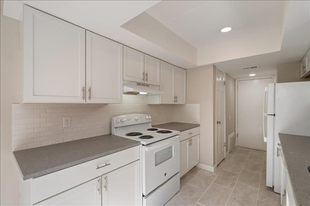 Crisp white cabinetry pairs with quartz counterto