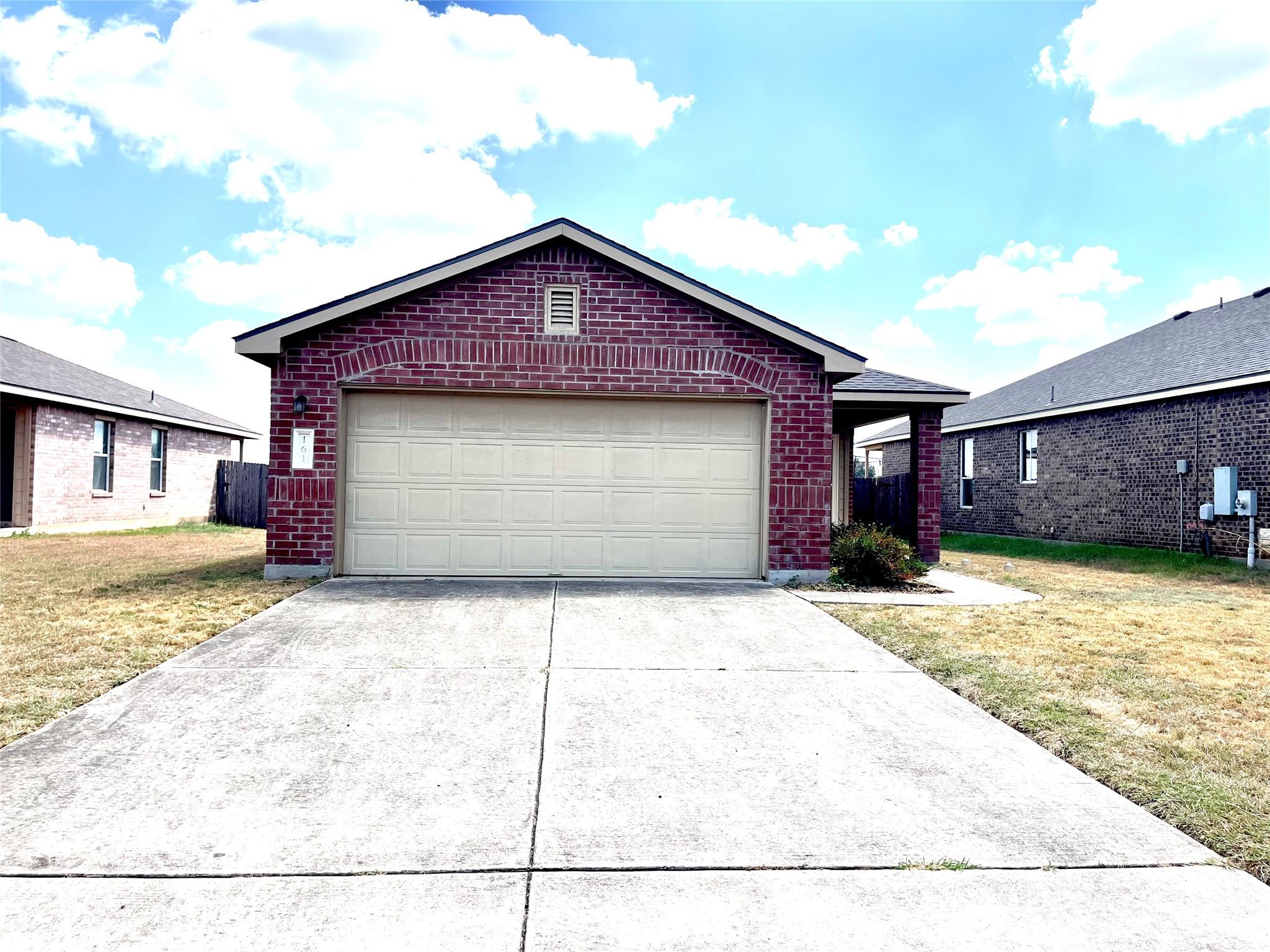 A spacious concrete driveway leads directly to a 