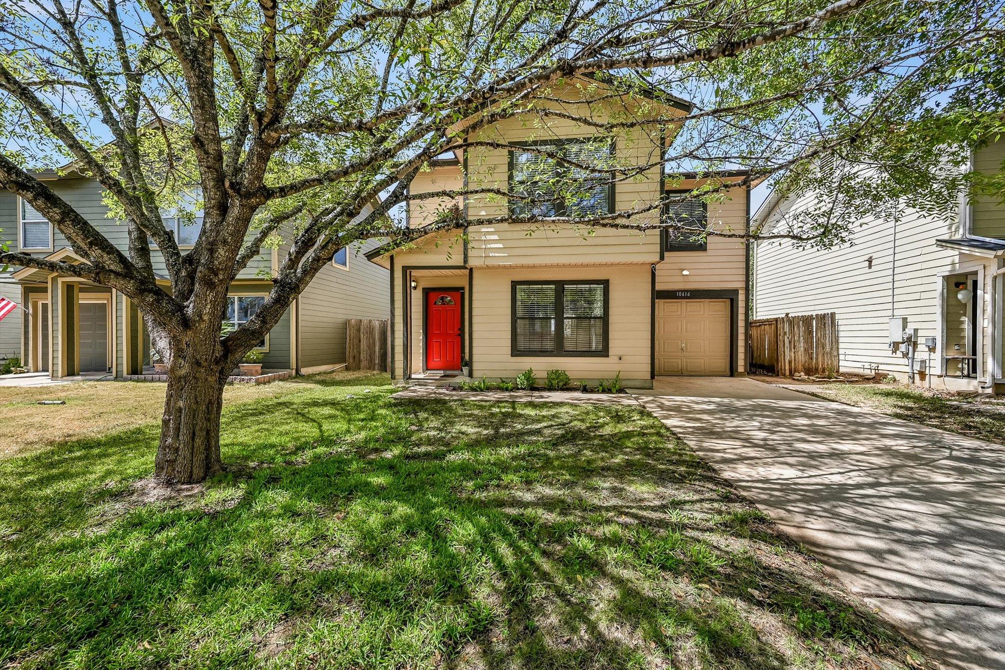 Mature trees shade the front lawn and concrete dr