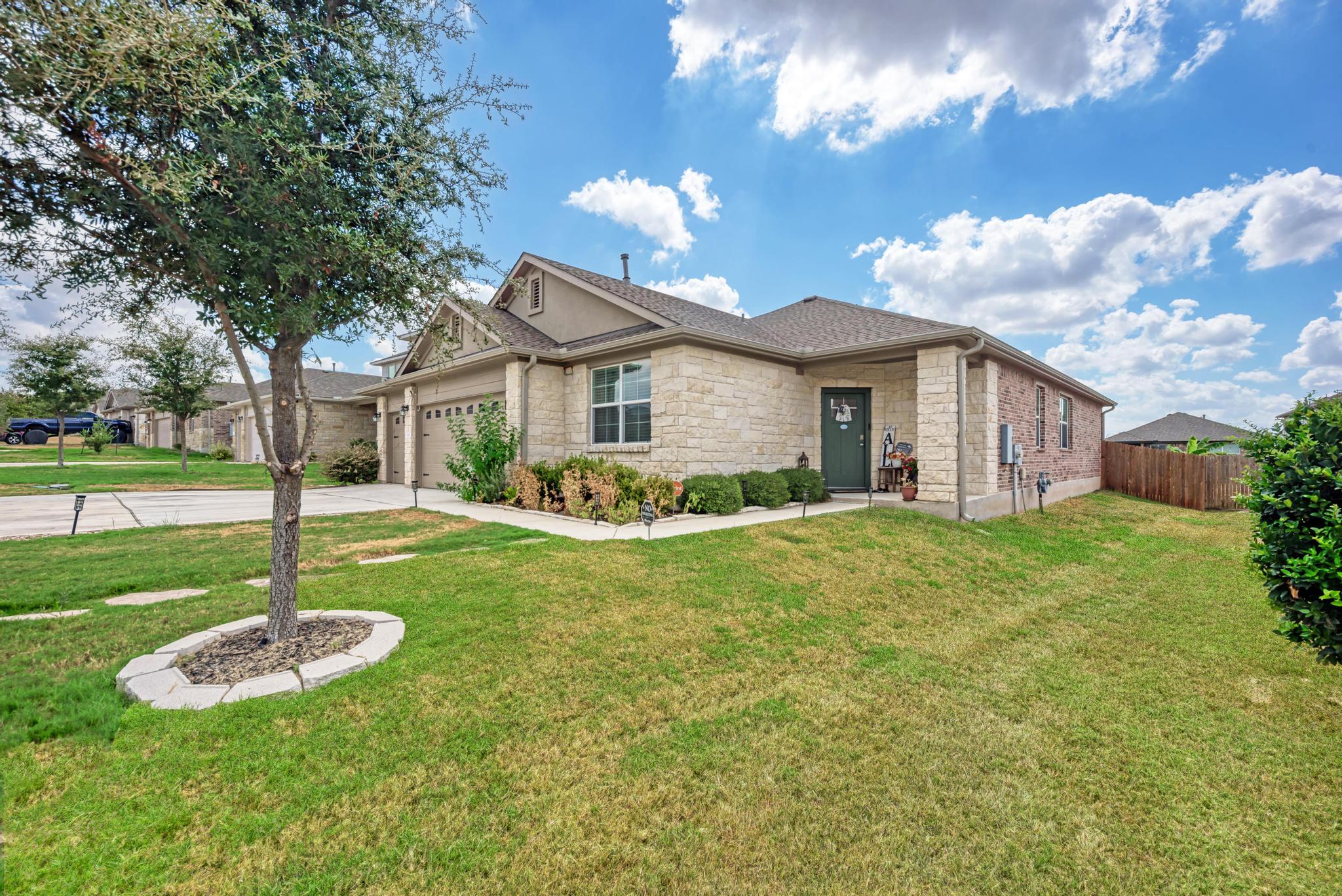 A classic stone exterior and manicured lawn creat