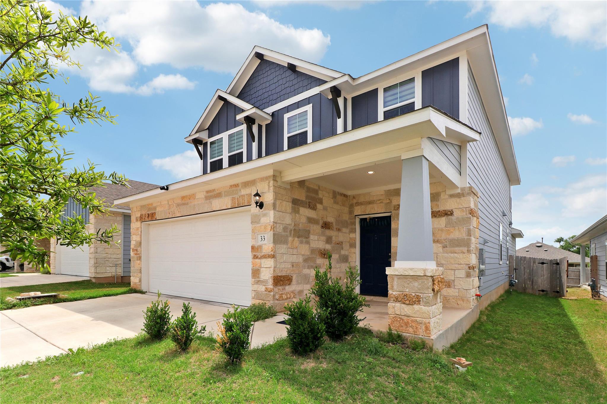 Textured stone veneer accents the exterior facade