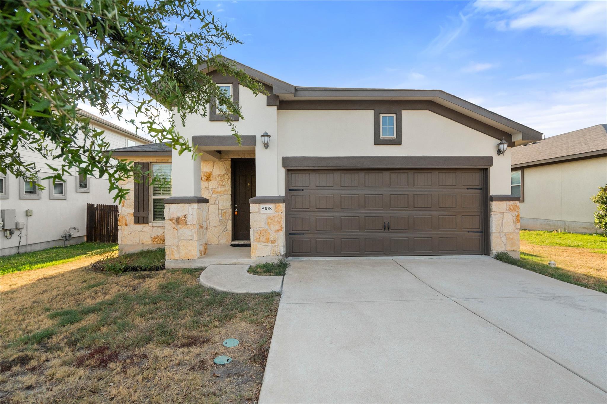 Natural stone accents and stucco siding elevate t