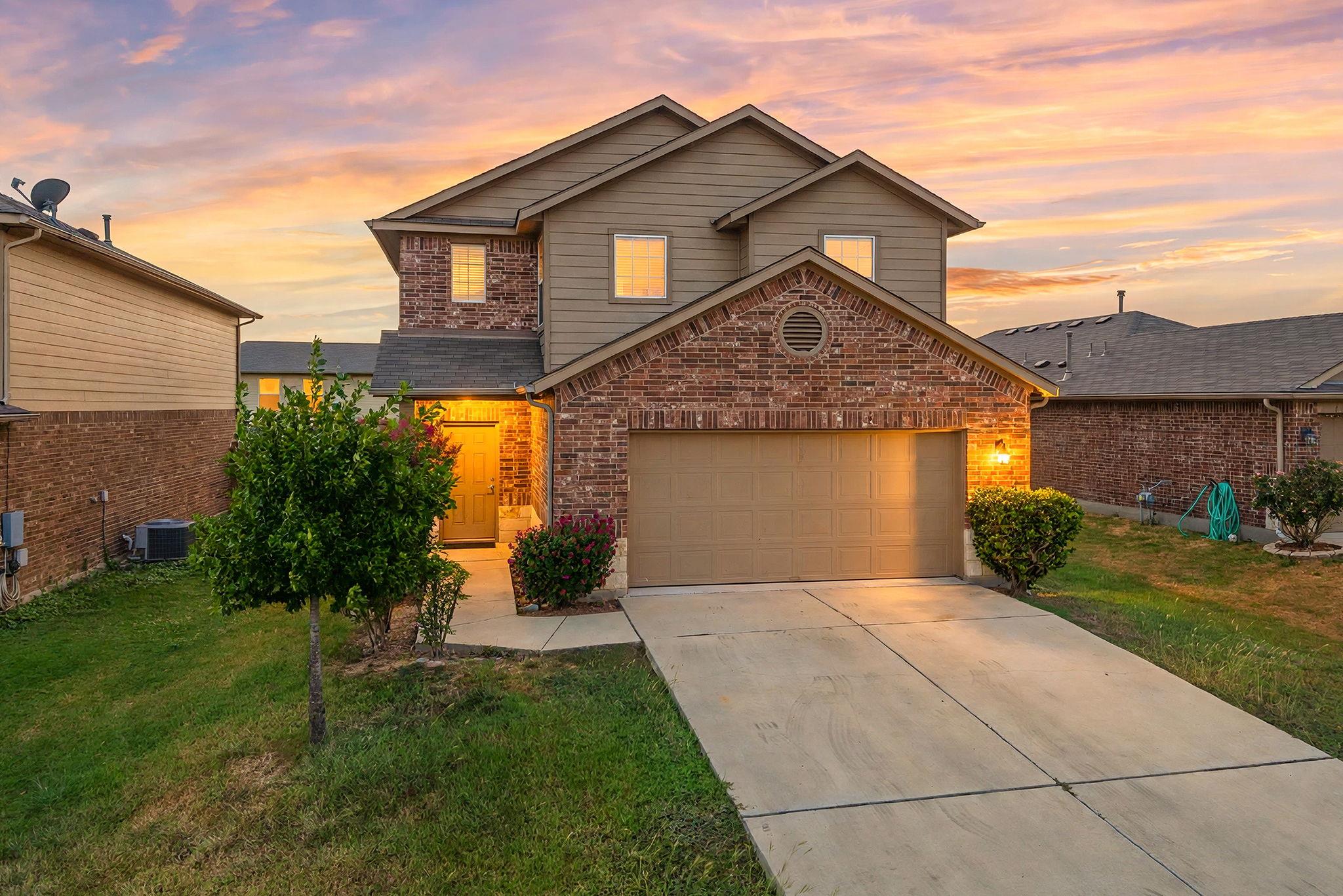 A classic brick and siding exterior features a fr