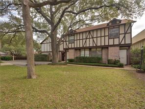 Mature trees shade a classic Tudor-inspired exter