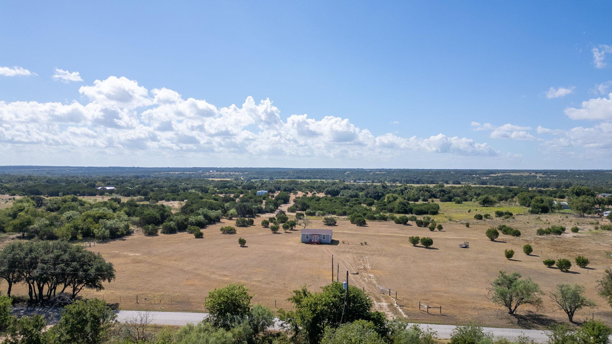 Vast open acreage rolls toward the horizon under 