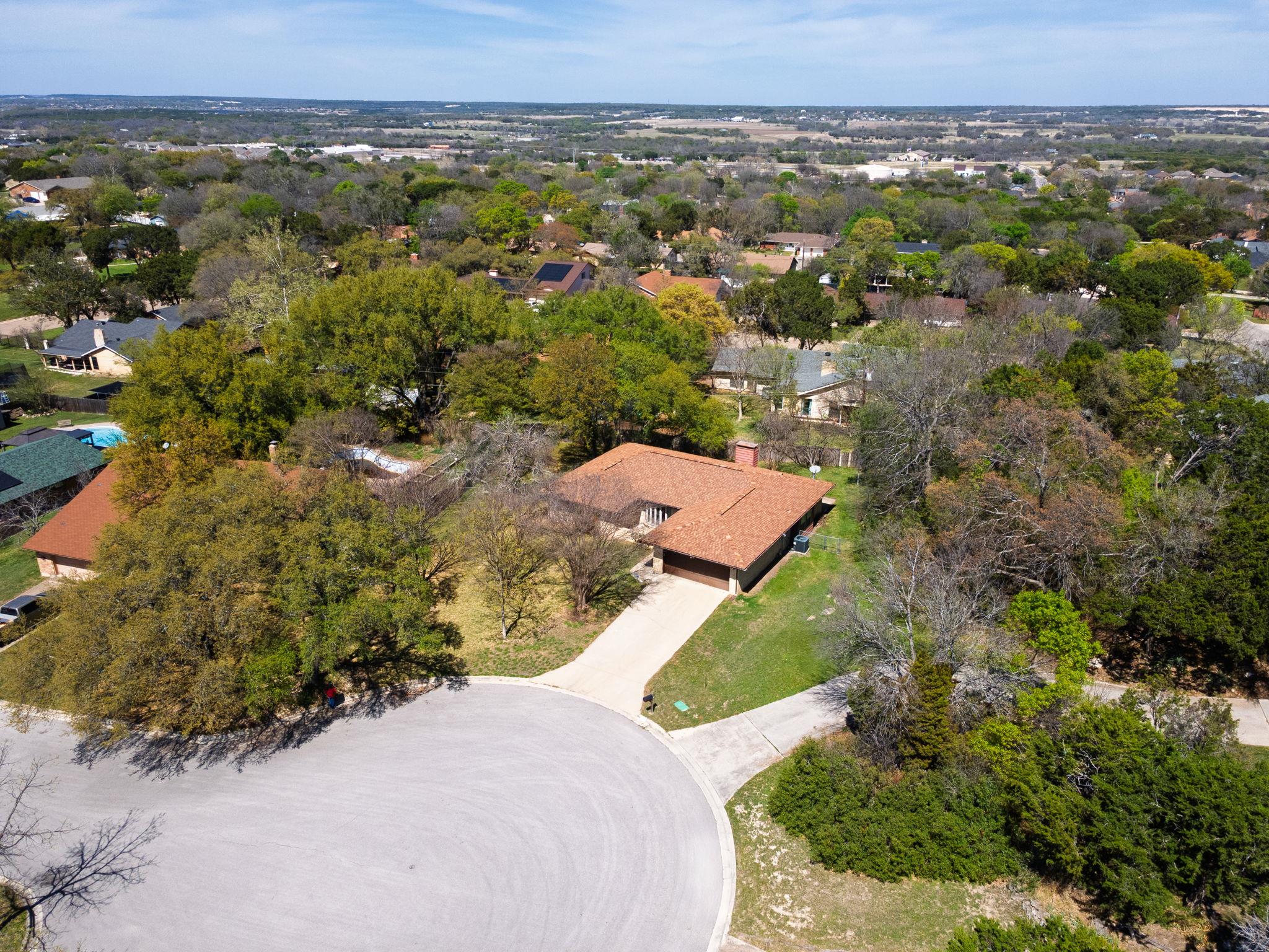 Mature trees surround this classic suburban home 
