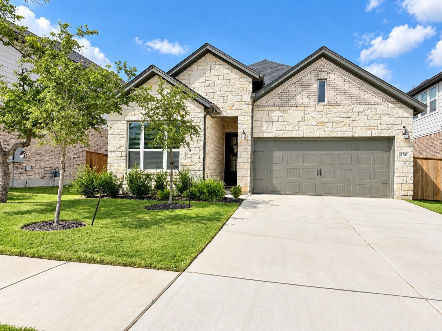 A classic stone facade and tidy lawn create an in