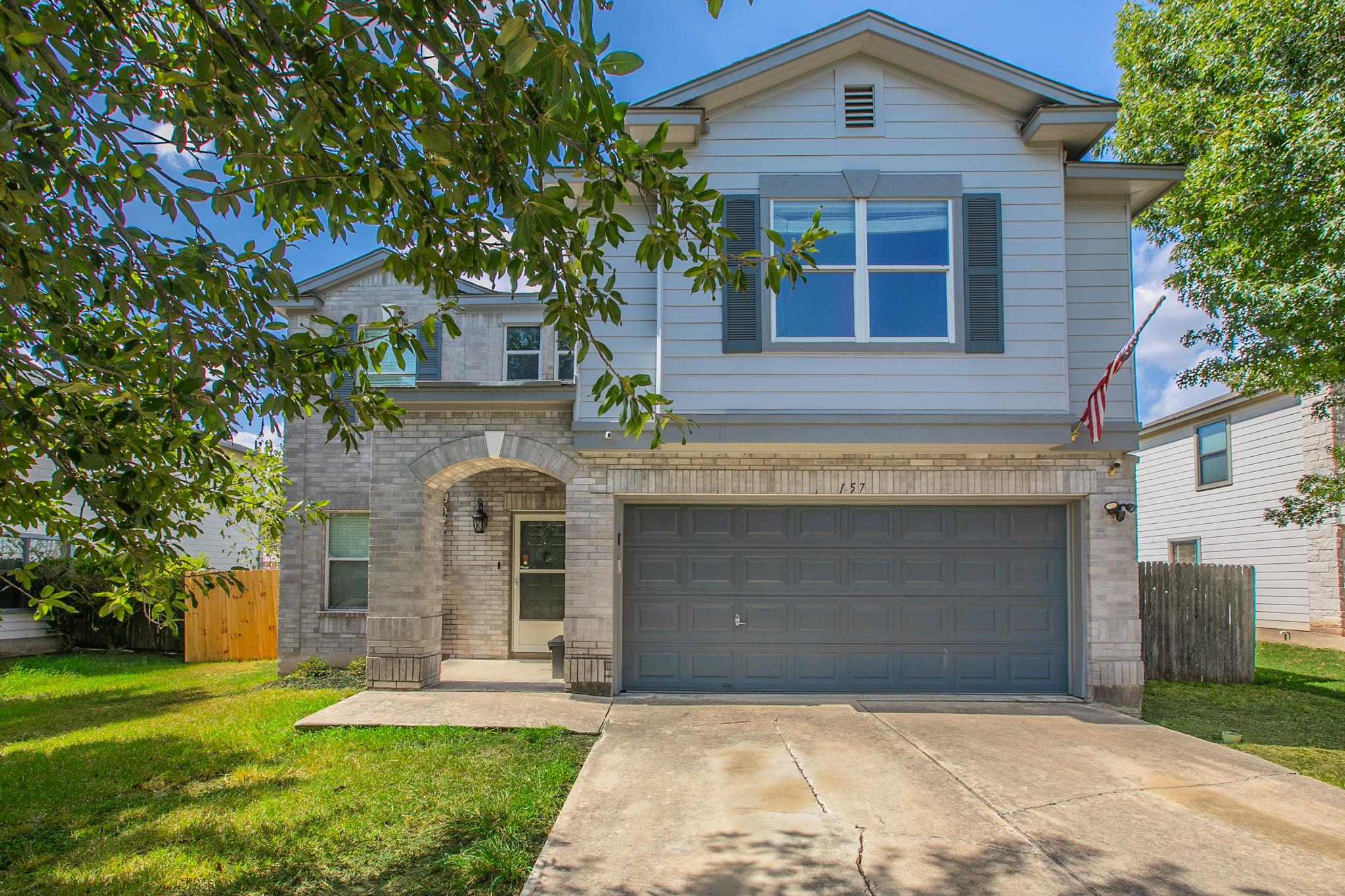 A classic stone and siding exterior integrates a 