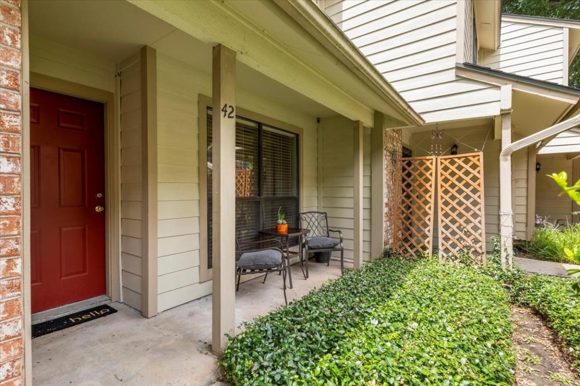 Welcoming front porch entry framed by siding, bri