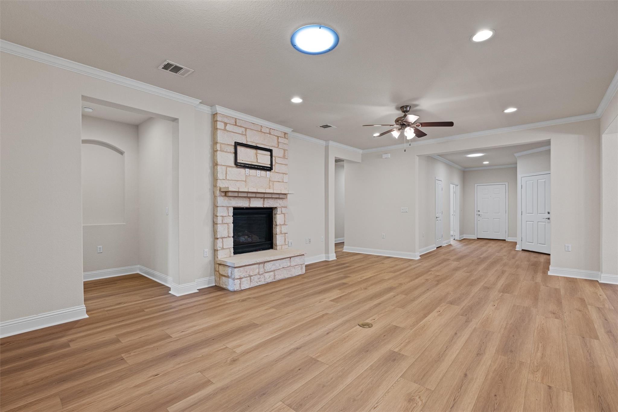 An inviting stone fireplace anchors this open liv