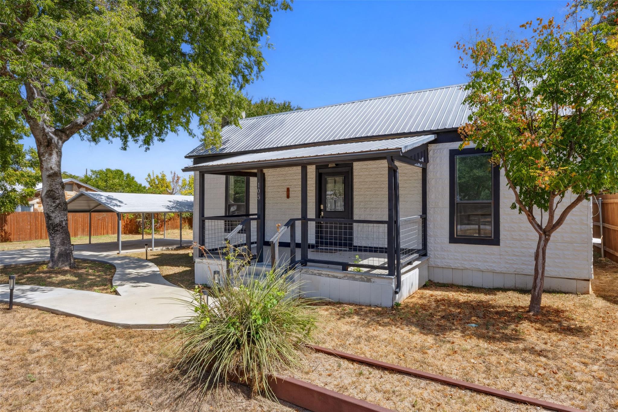 Classic metal roofing and a welcoming front porch