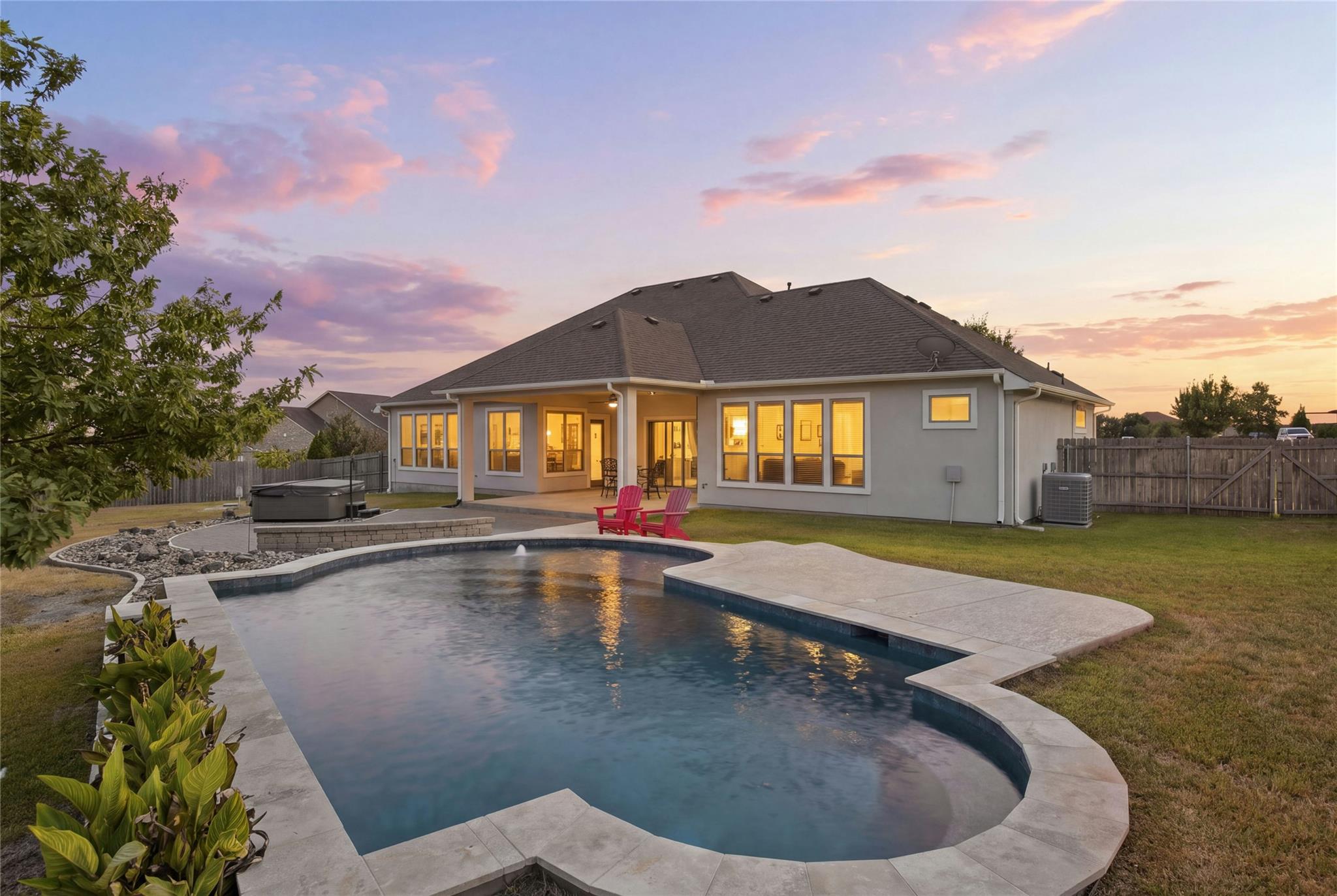 An inviting backyard oasis features a custom swim