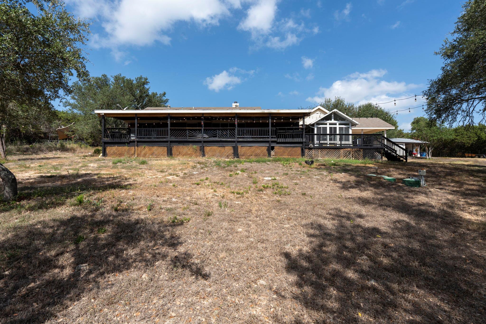 A spacious wooden deck extends across the rear of