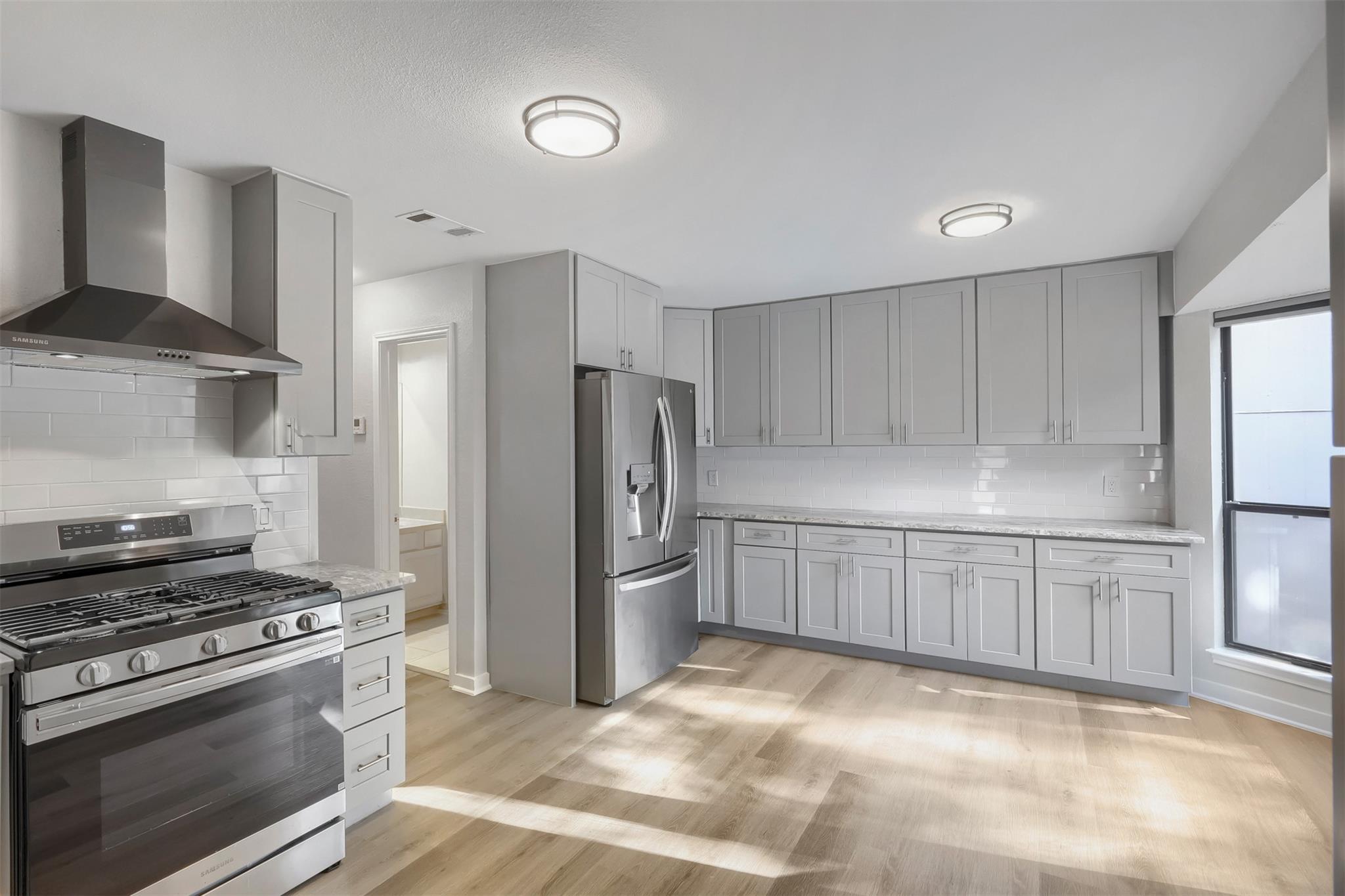 Gleaming stone countertops and modern stainless s