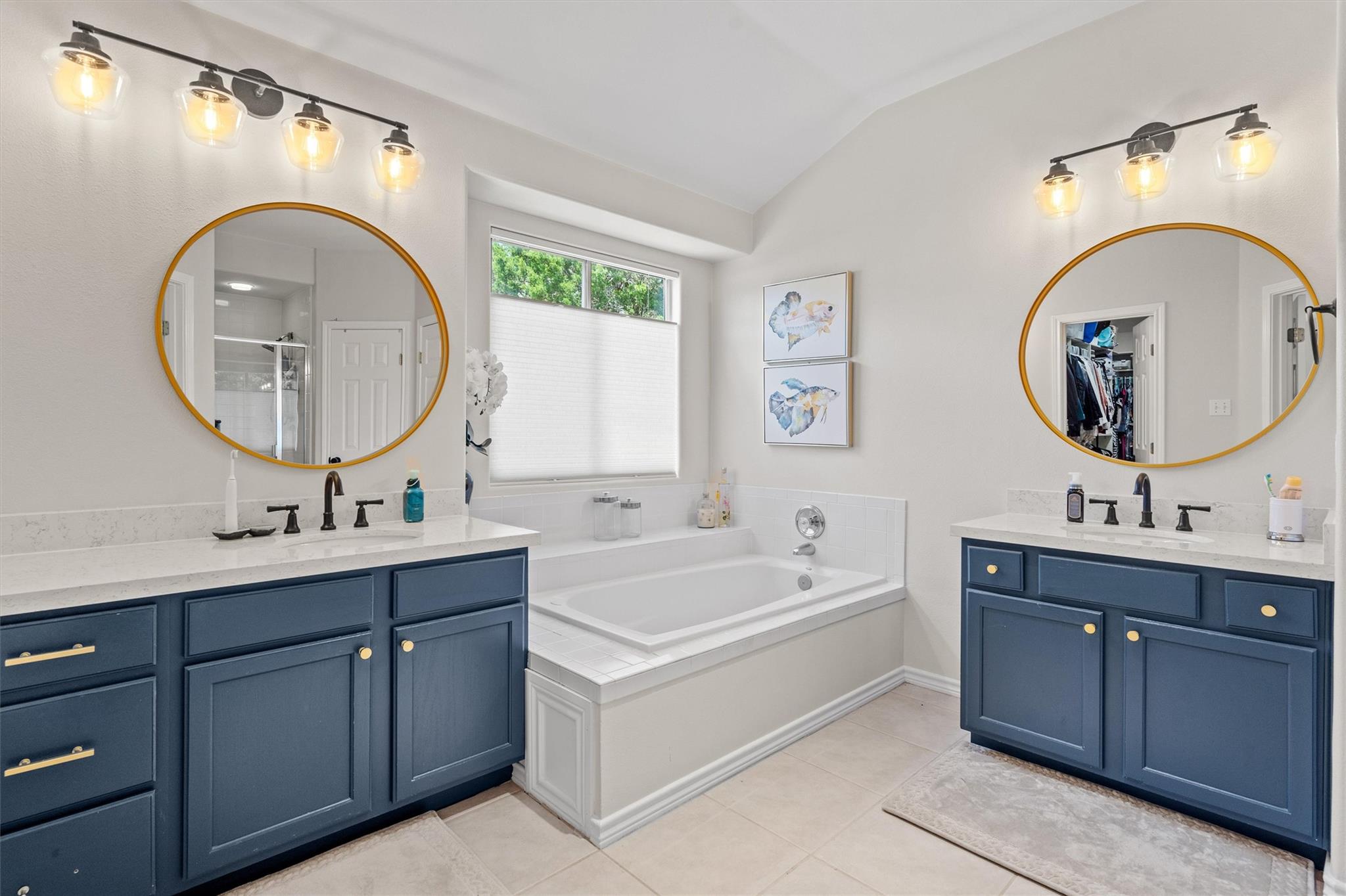 Full bathroom with vaulted ceiling, two vanities,