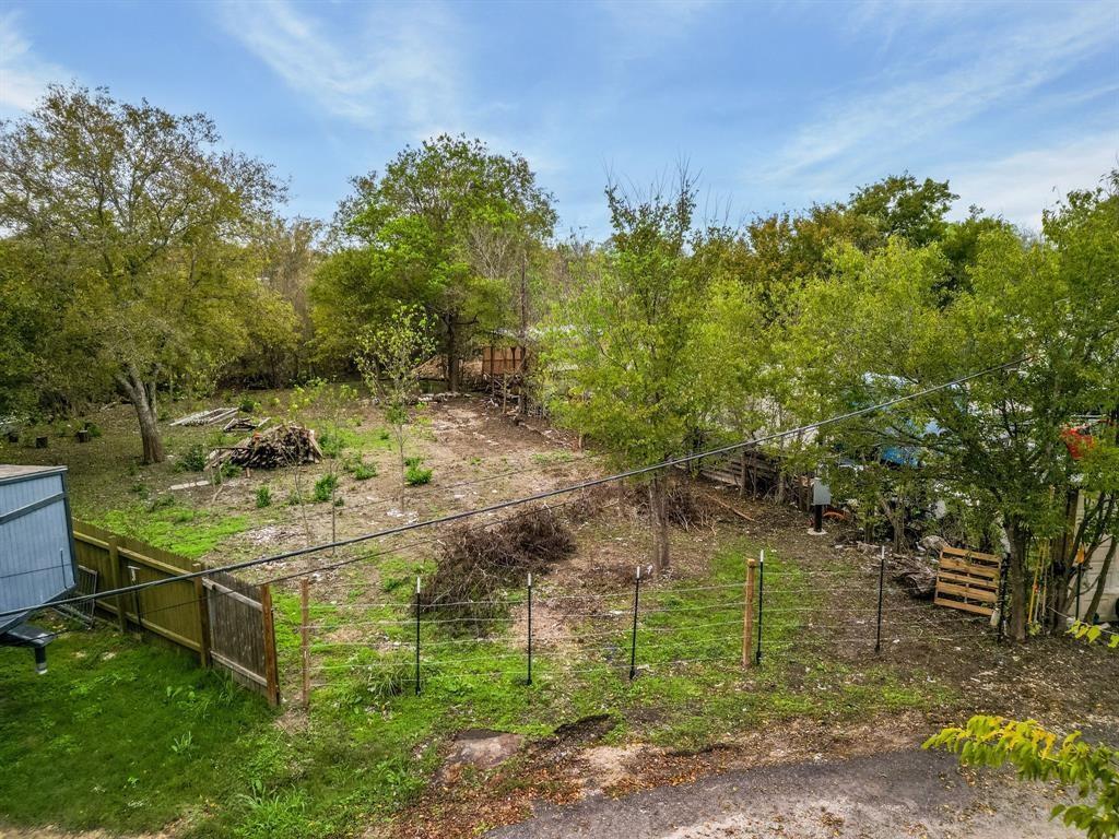 Mature trees line the boundaries of this spacious