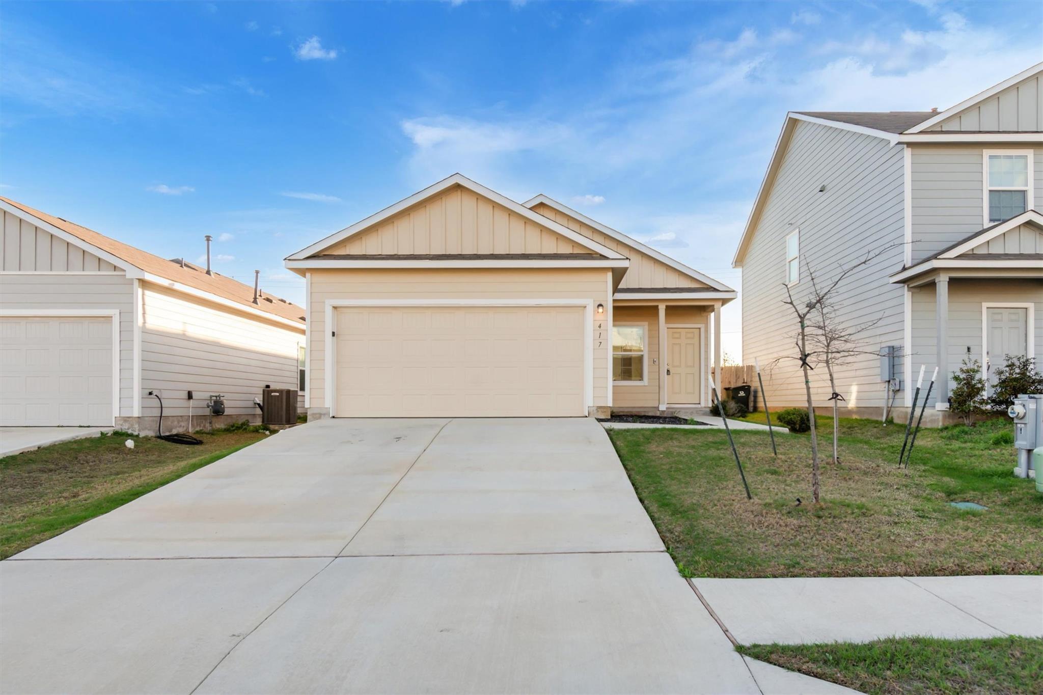 A concrete driveway leads to the attached garage 