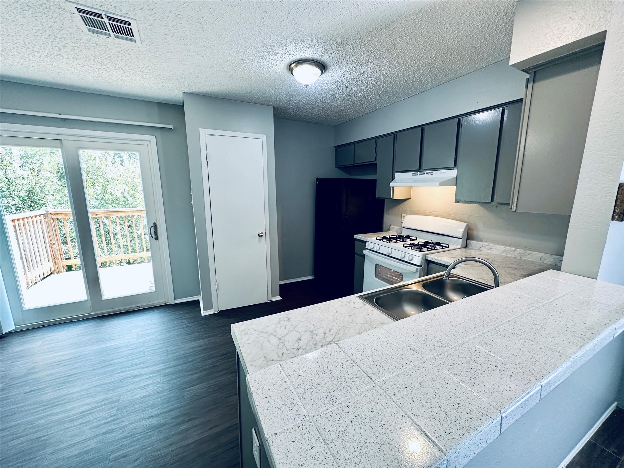Granite-look tile counters and sliding glass door