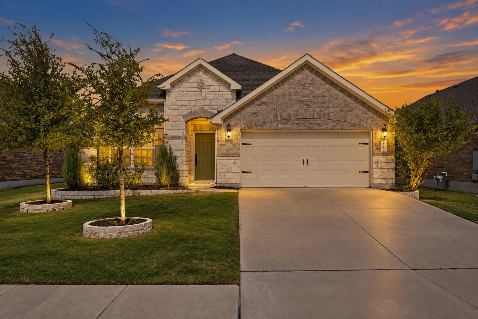 Textured stone facade accents highlight this beau
