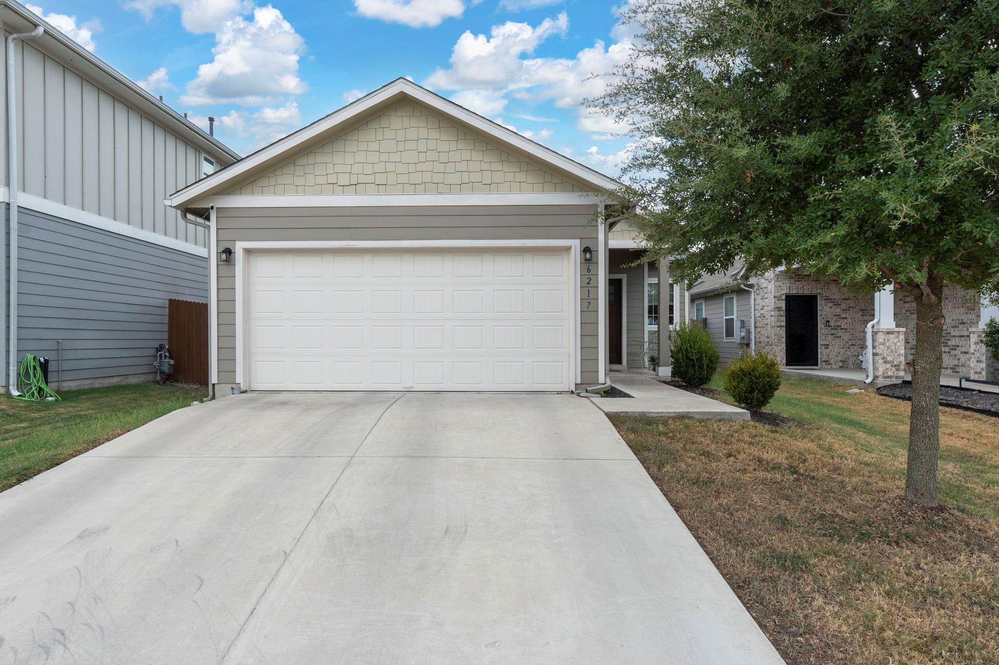 A wide concrete driveway leads toward the integra