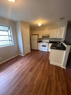 Rich wood flooring anchors this culinary space, i